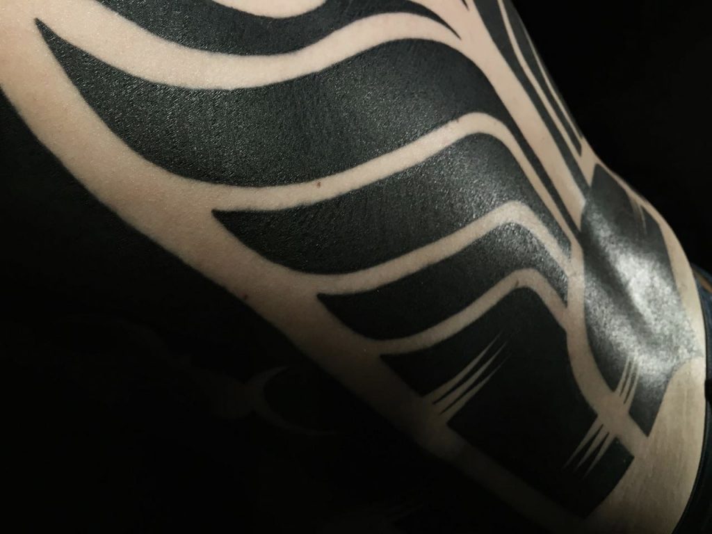 Hanumantra bold minimal blackwork backpiece tattoo birmingham shrewsbury un1ty style3